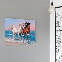 Horses running on a beach