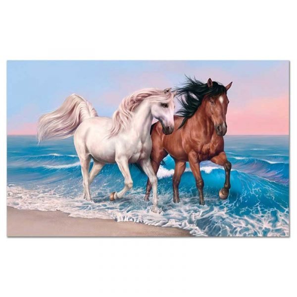 Horses running on a beach